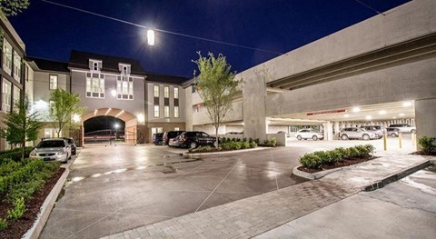 a parking lot with cars in front of a building