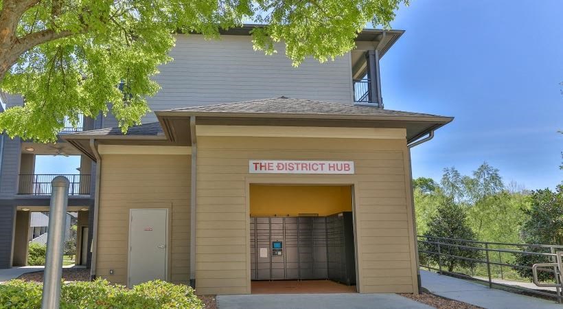 a building with a door and a sign that reads the district hub