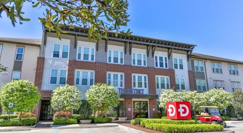 a large brick building with a dc sign in front of it
