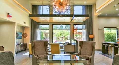 a lobby with chairs and a glass table