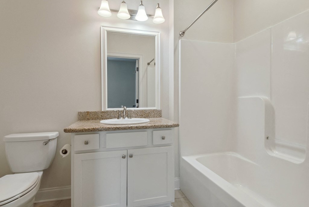 a bathroom with a toilet sink and bathtub
