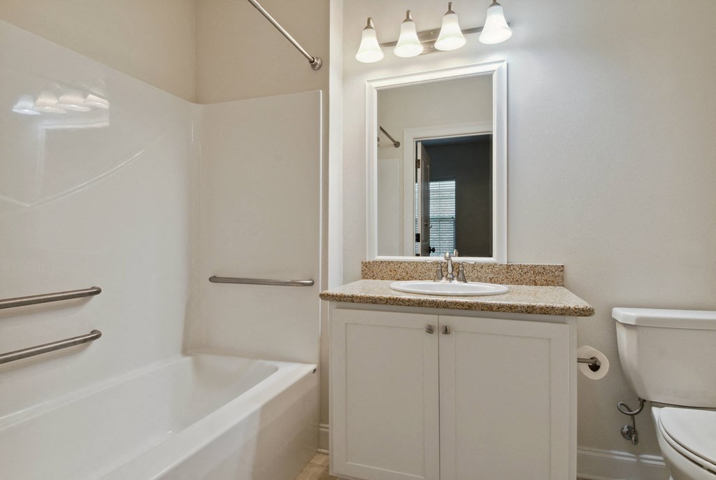 a bathroom with a sink toilet and bathtub