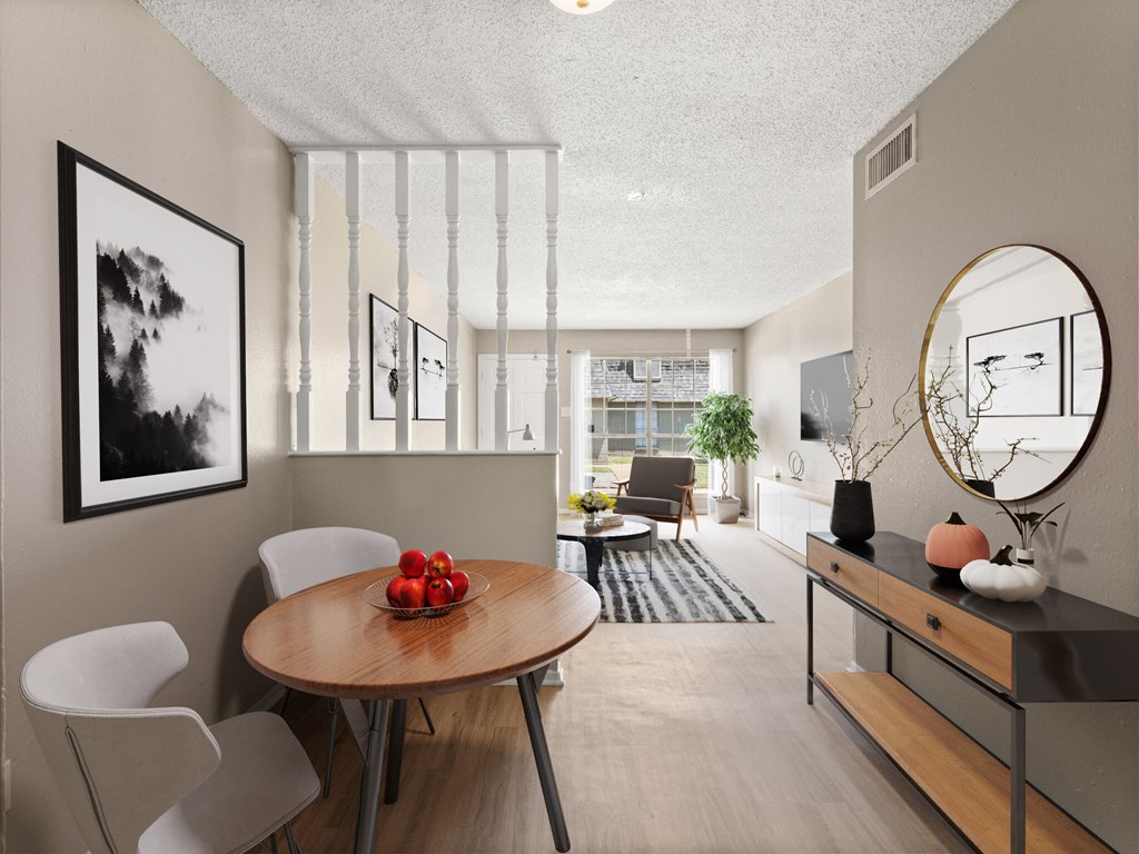 A modern dining room with a round table and chairs.