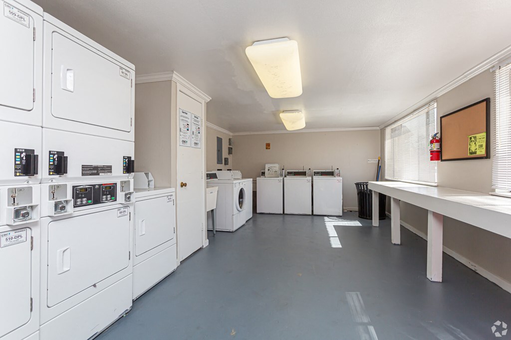 A laundry room with washers and dryers.