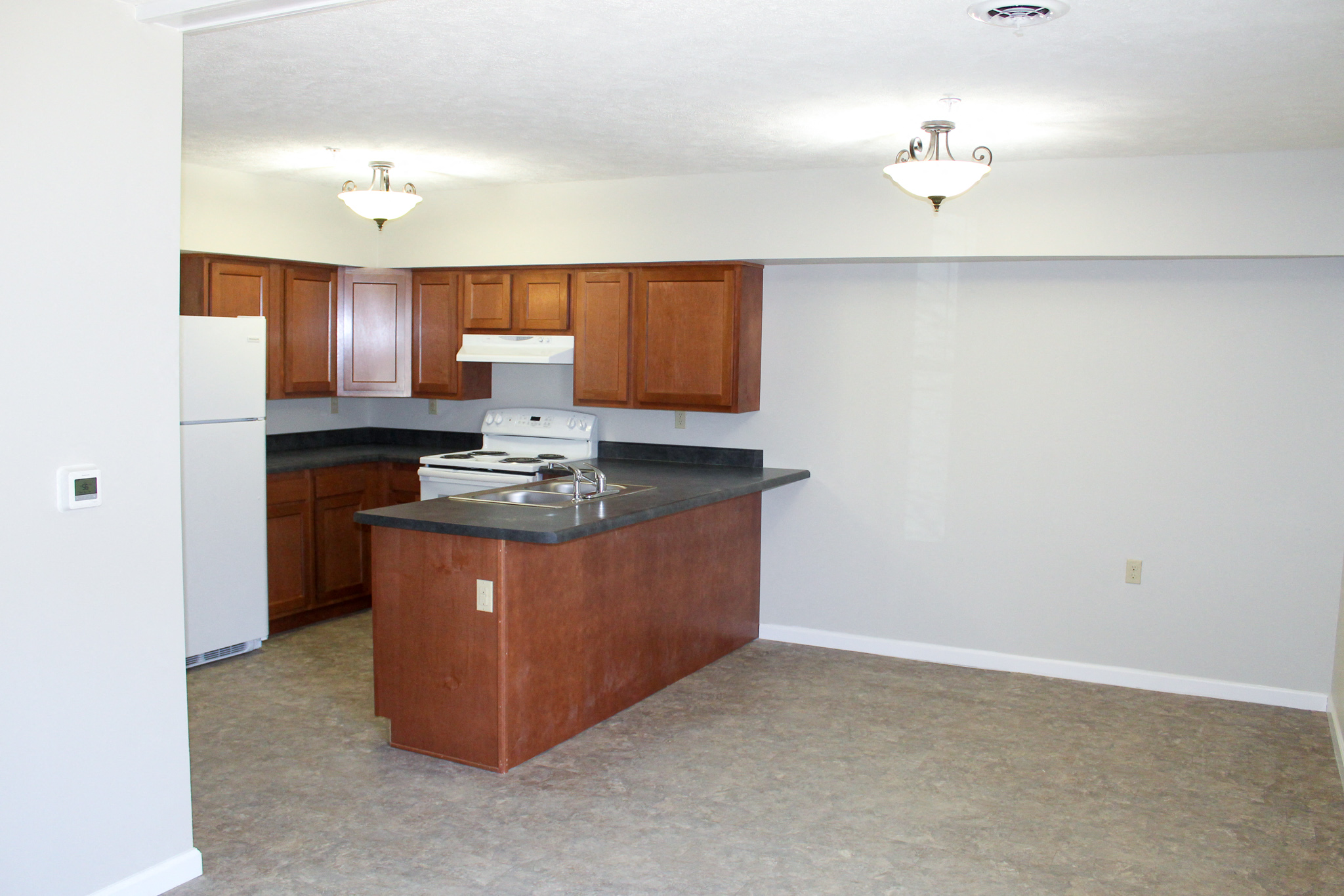 an empty kitchen with an island in the middle