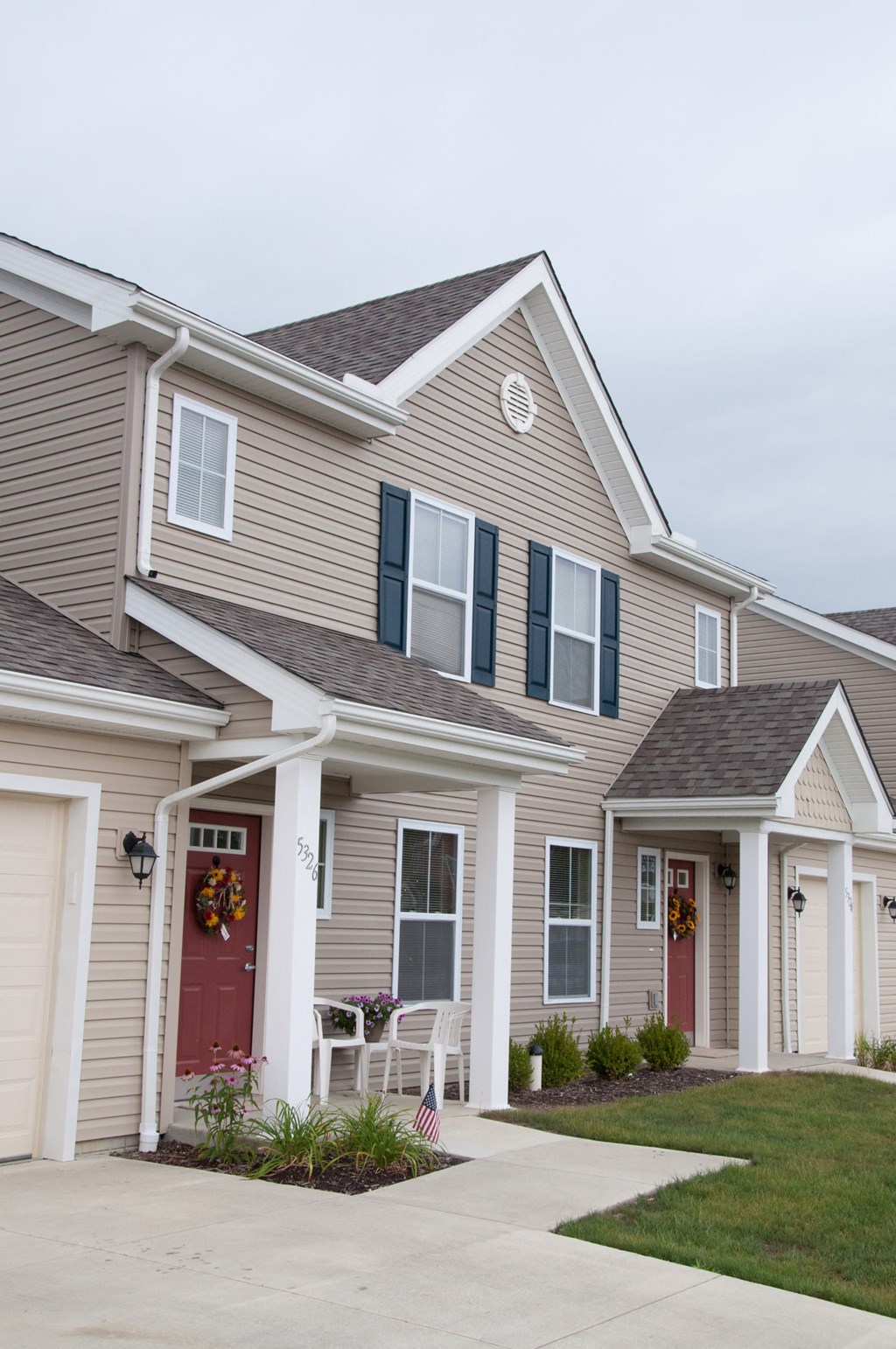 a row of houses with a sidewalk in front of them