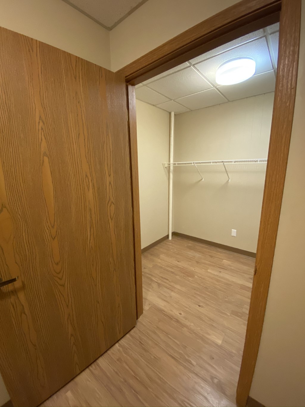 an empty room with a door to a closet