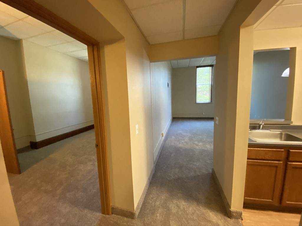an empty room with a sink and a window in a house