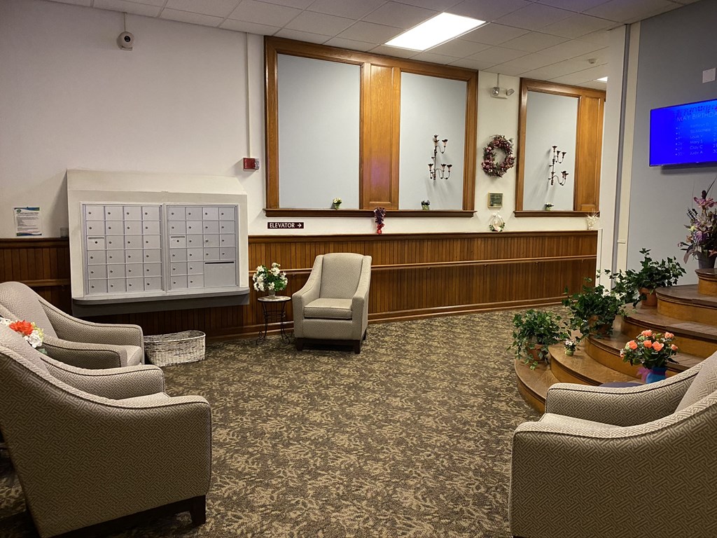 a lobby with chairs and a calendar on the wall