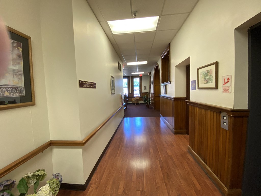 a view of a hallway in a hospital with wood floors