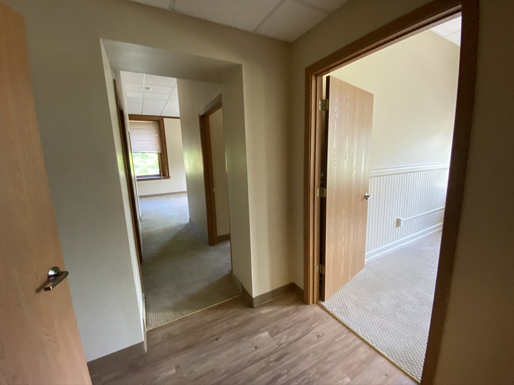 the view from the master bedroom looking into the living room and dining room
