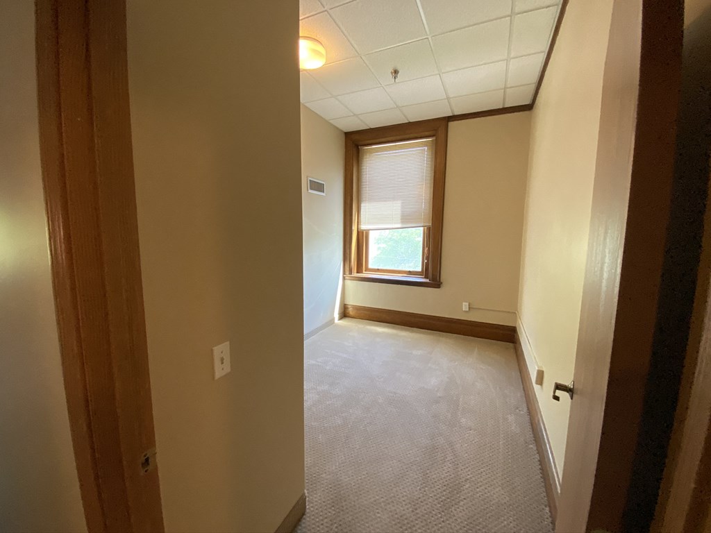 an empty room with a window and a door