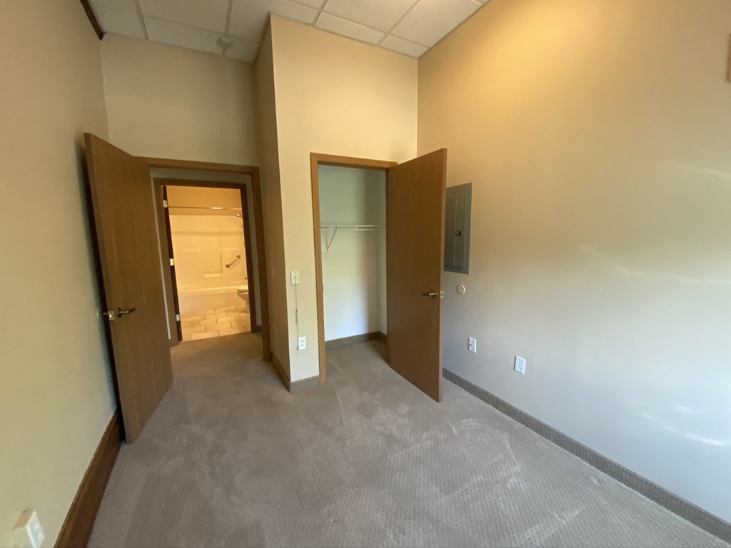 the living room and bedroom of an apartment at the flats at westbury