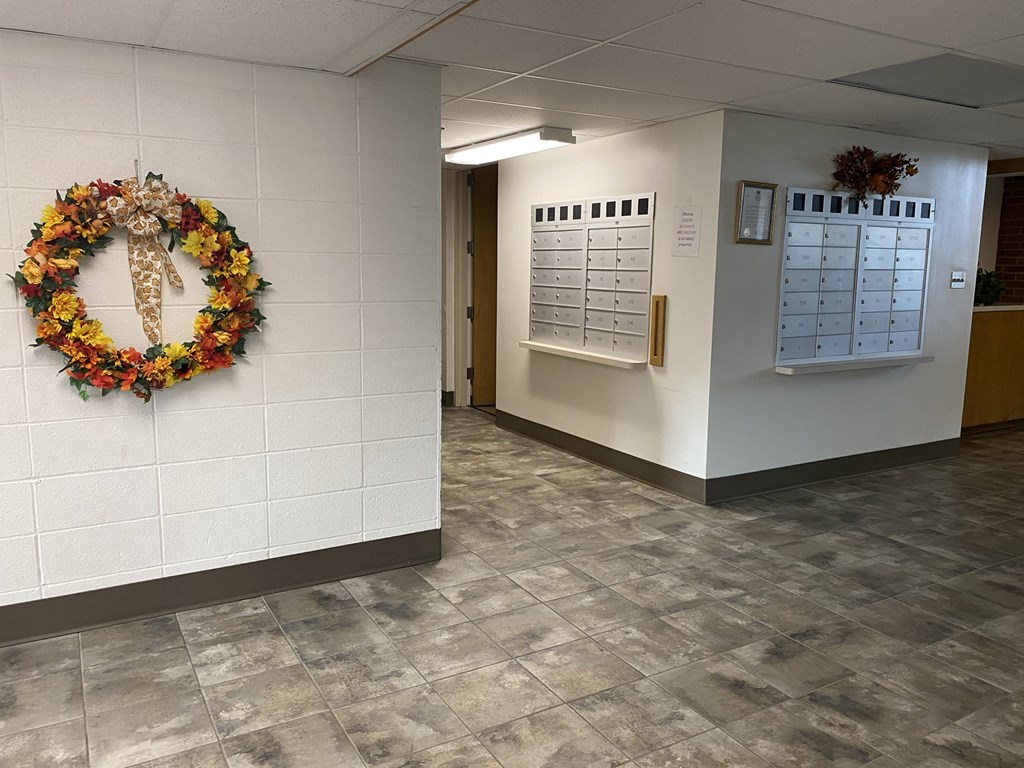 an office with a wreath and a calendar on the wall