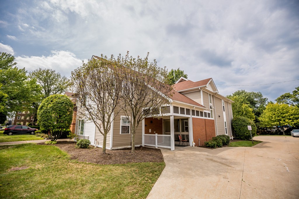 the front of a house with a porch and a driveway