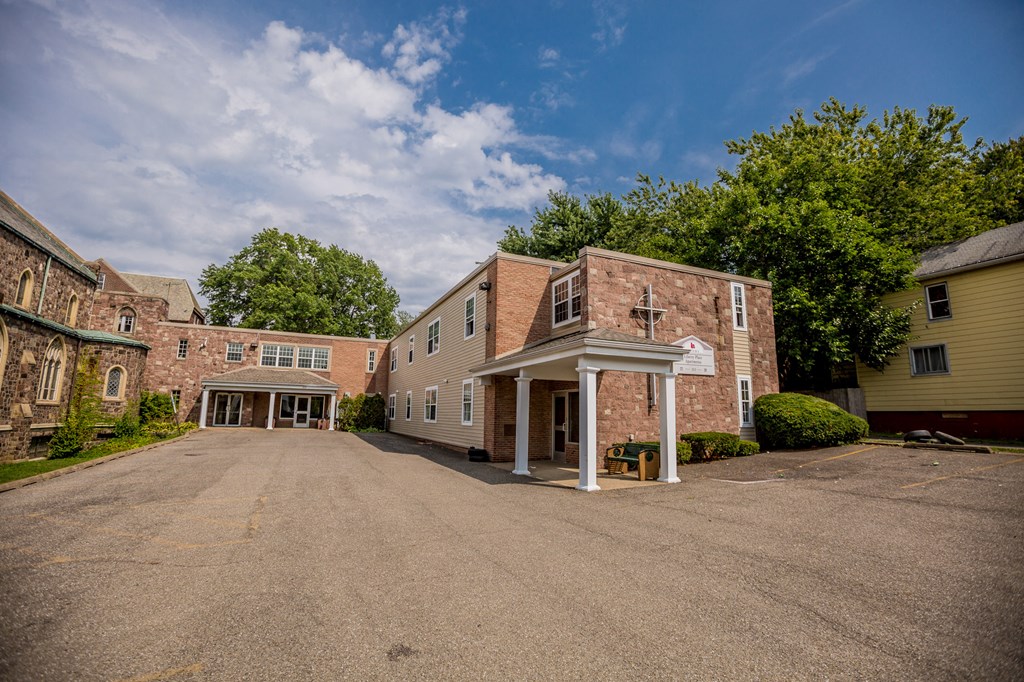 an empty parking lot in front of a brick building