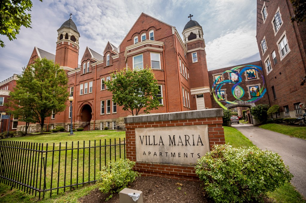 the facade of villa maria apartments on a sunny day