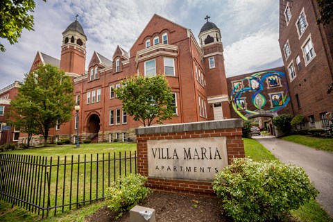 the facade of villa maria apartments on a sunny day