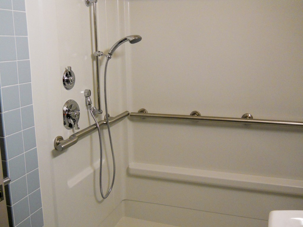 a bathroom with a shower and a bath tub