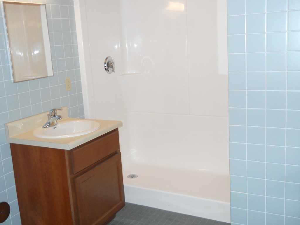 a bathroom with a white tub and a sink
