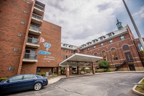 a car is parked in front of a brick building