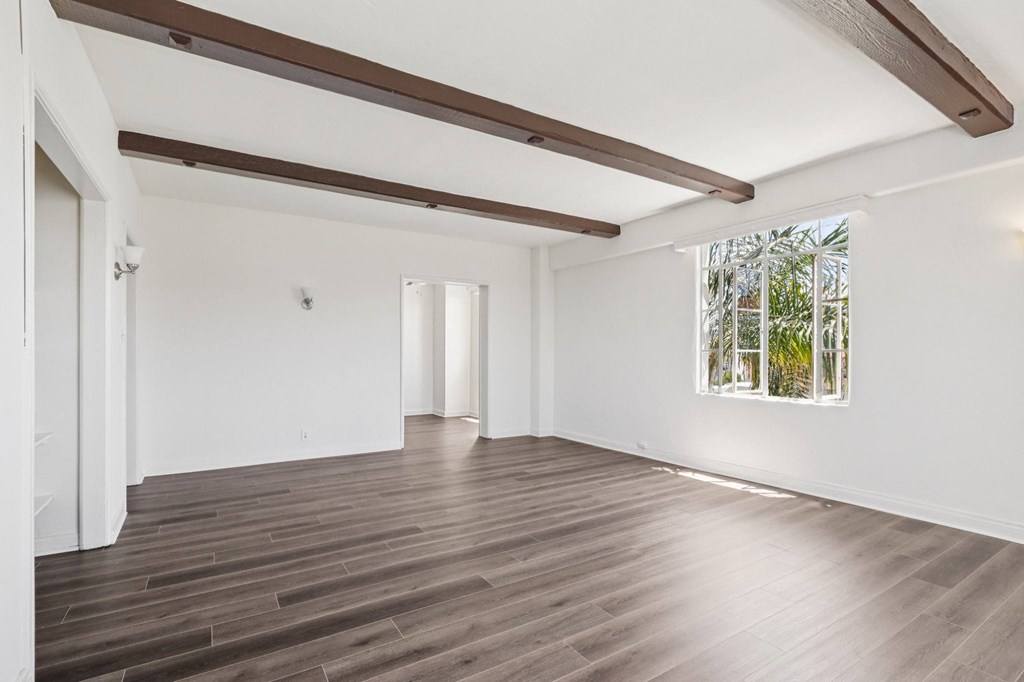 A room with wooden floors and white walls.