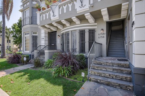 A house with a white facade and a black door.