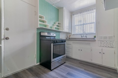 A kitchen with a stove and oven in it.