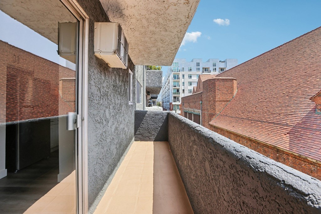 A long, narrow, outdoor walkway between two buildings.