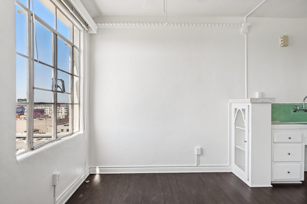 A white room with a window and a sink.