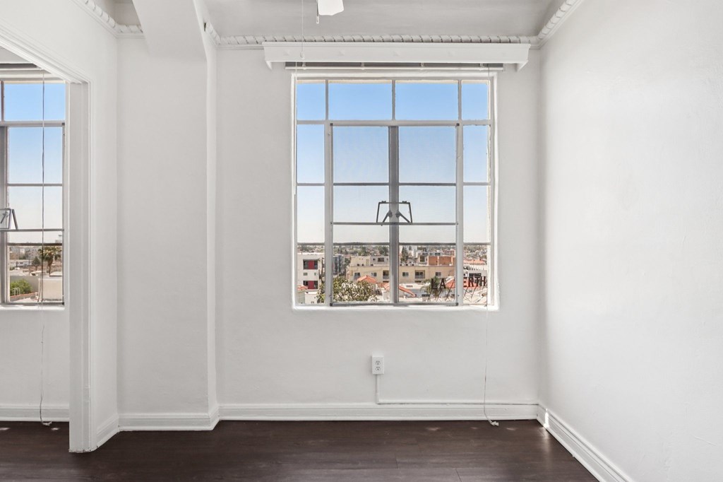 A room with a large window and a view of the city.