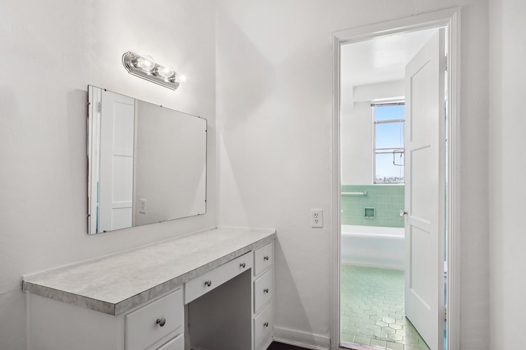 A bathroom with a mirror and a cabinet.