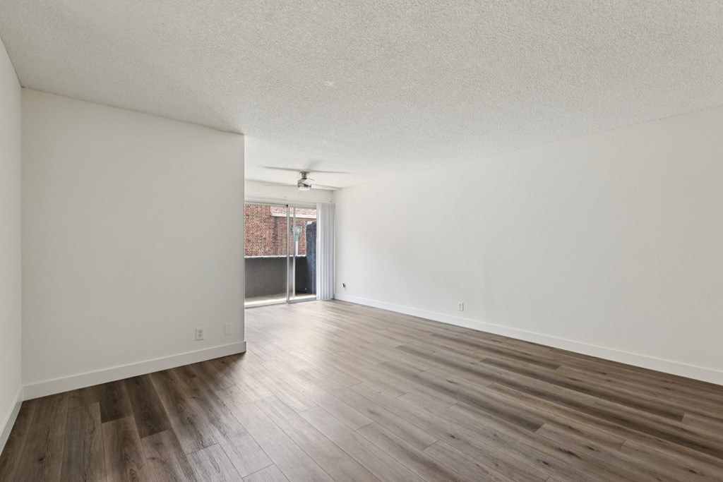 A room with wooden floors and white walls.