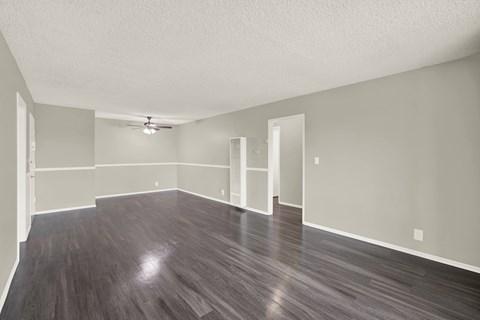 A large empty room with wooden floors and white walls at The Square in Downey, CA, 90242