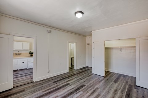 A room with a wooden floor and white walls.