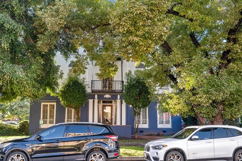 Two cars parked in front of a house.