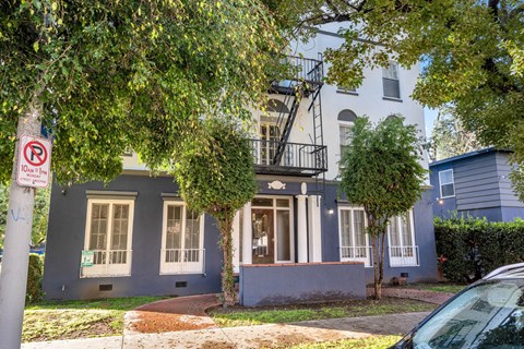 A blue house with a no parking sign in front.