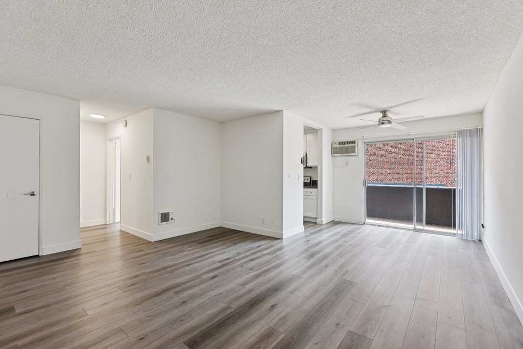 A room with wooden floors and a ceiling fan.