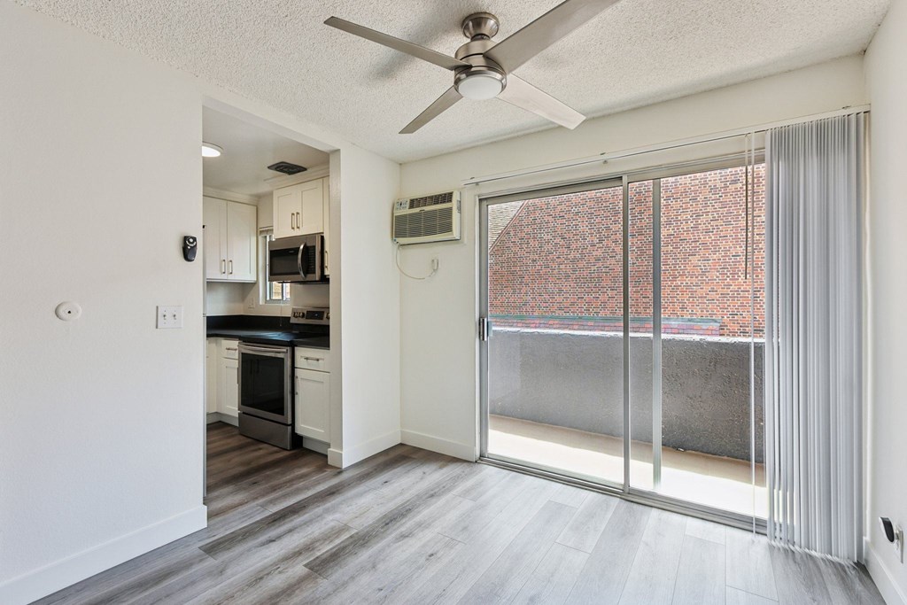 A modern kitchen with a view of a brick building outside.