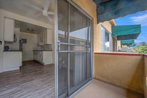 a sliding glass door opens into the kitchen and living room