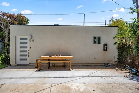 A small house with a wooden table outside.