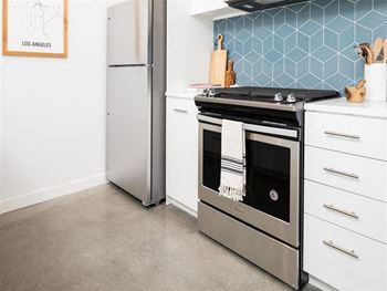 Kitchen with range and stainless refrigerator at the perch, Los Angeles