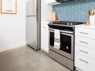 Kitchen with range and stainless refridgerator at the perch, Los Angeles, CA 90065