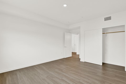 a living room with white walls and a wood floor