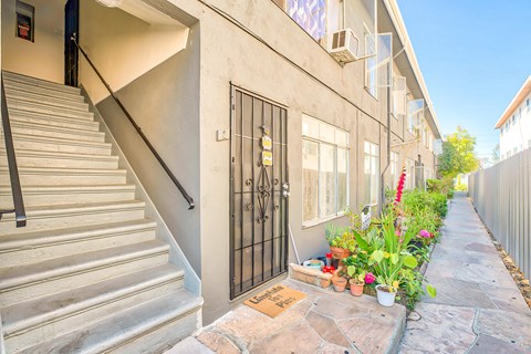 A staircase with a metal railing leads up to a door.