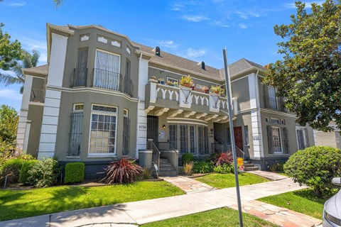 A two-story house with a balcony and a front porch.