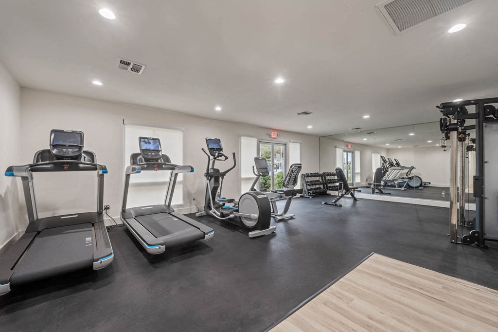 the gym is equipped with treadmills and other fitness equipment at Monterra Ridge Apartments, California,91351