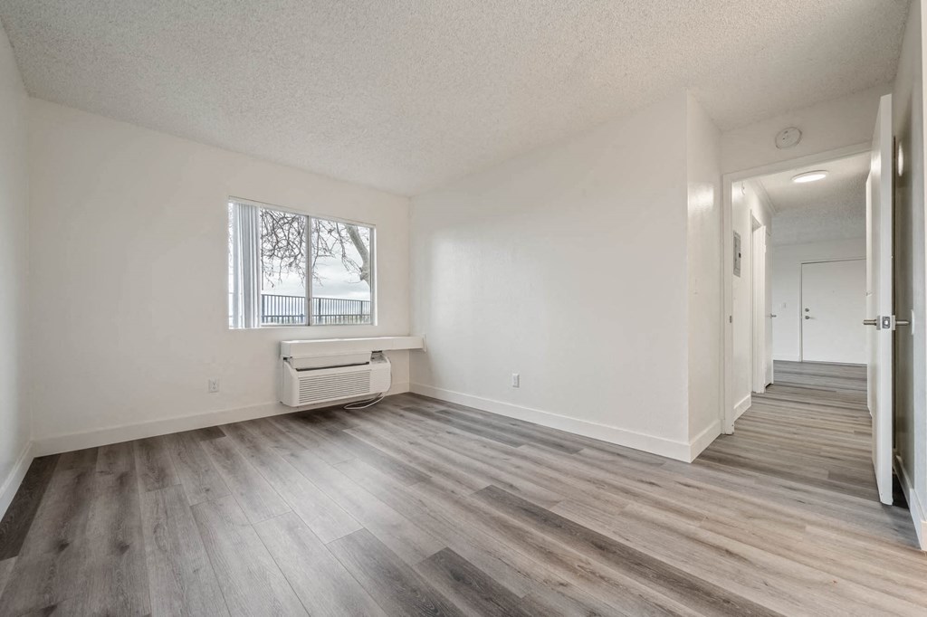 a living room with wood flooring and a window at Monterra Ridge Apartments, Canyon Country ,91351