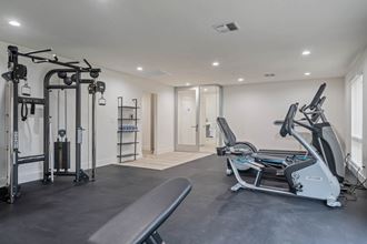 a gym with treadmills and other exercise equipment in a room