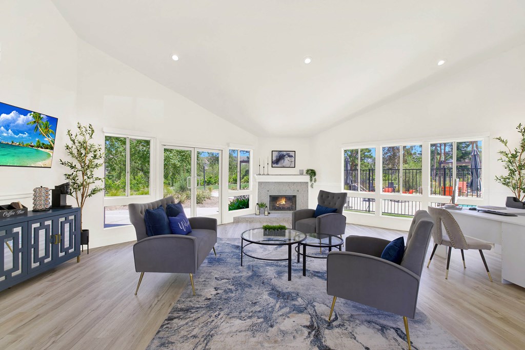 a living room with couches and chairs and a fireplace at Monterra Ridge Apartments, Canyon Country